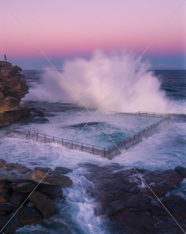 body of water crashing on black steel fence