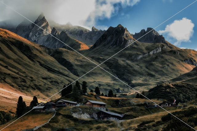 brown house in between of mountains