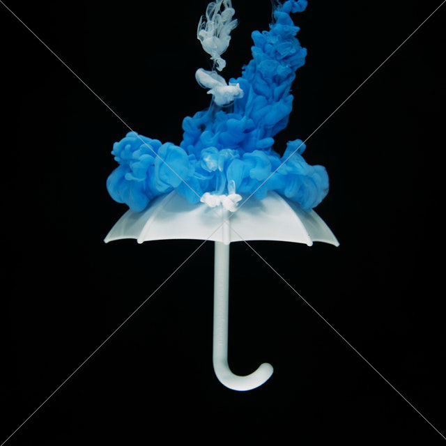 white umbrella with blue smoke